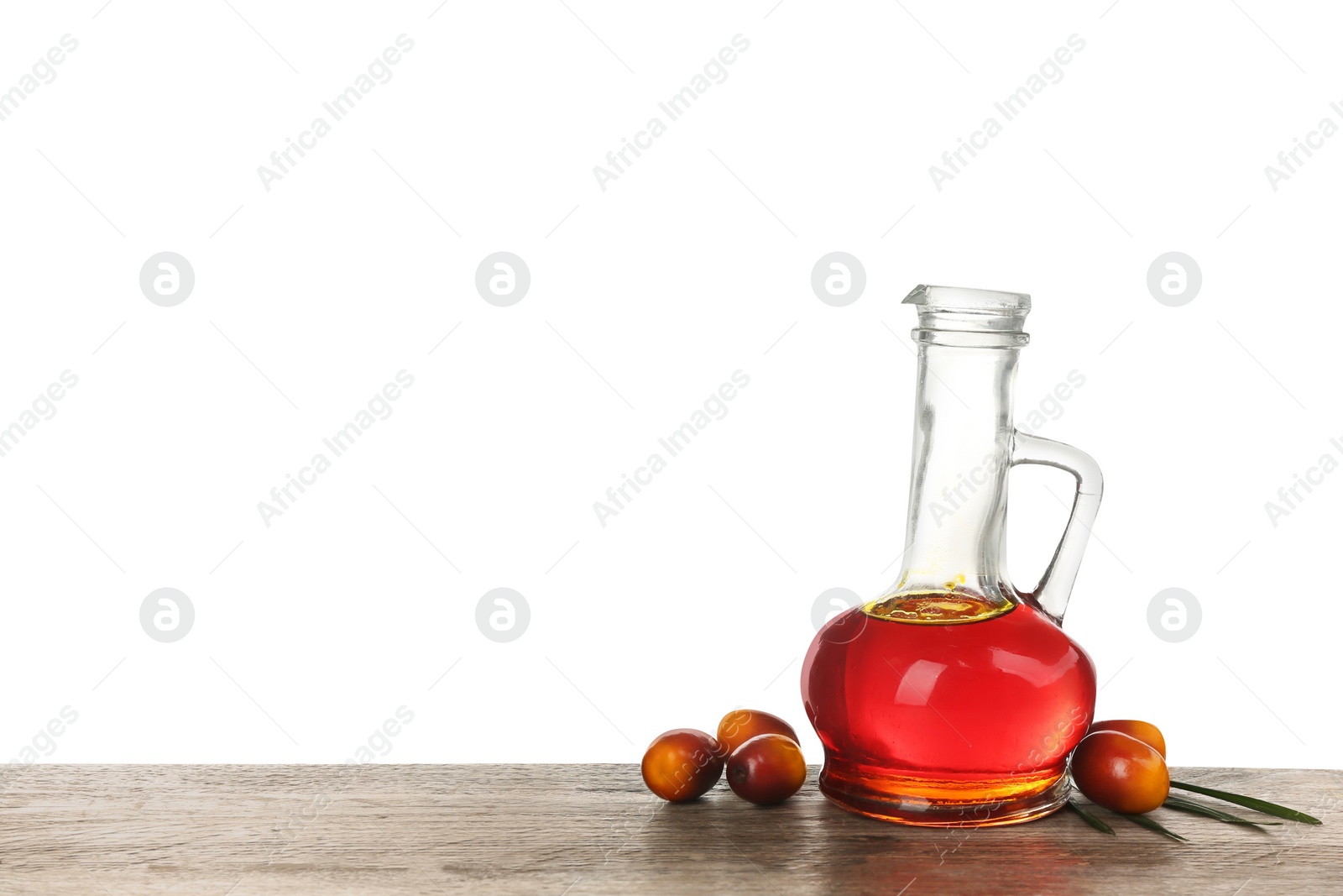Image of Palm oil, tropical leaf and fruits on wooden table against white background