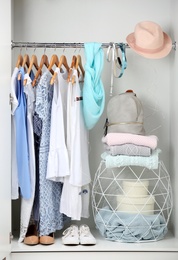 Photo of Women clothing on hangers in wardrobe