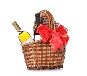 Festive basket with bottles of wine and gift on white background