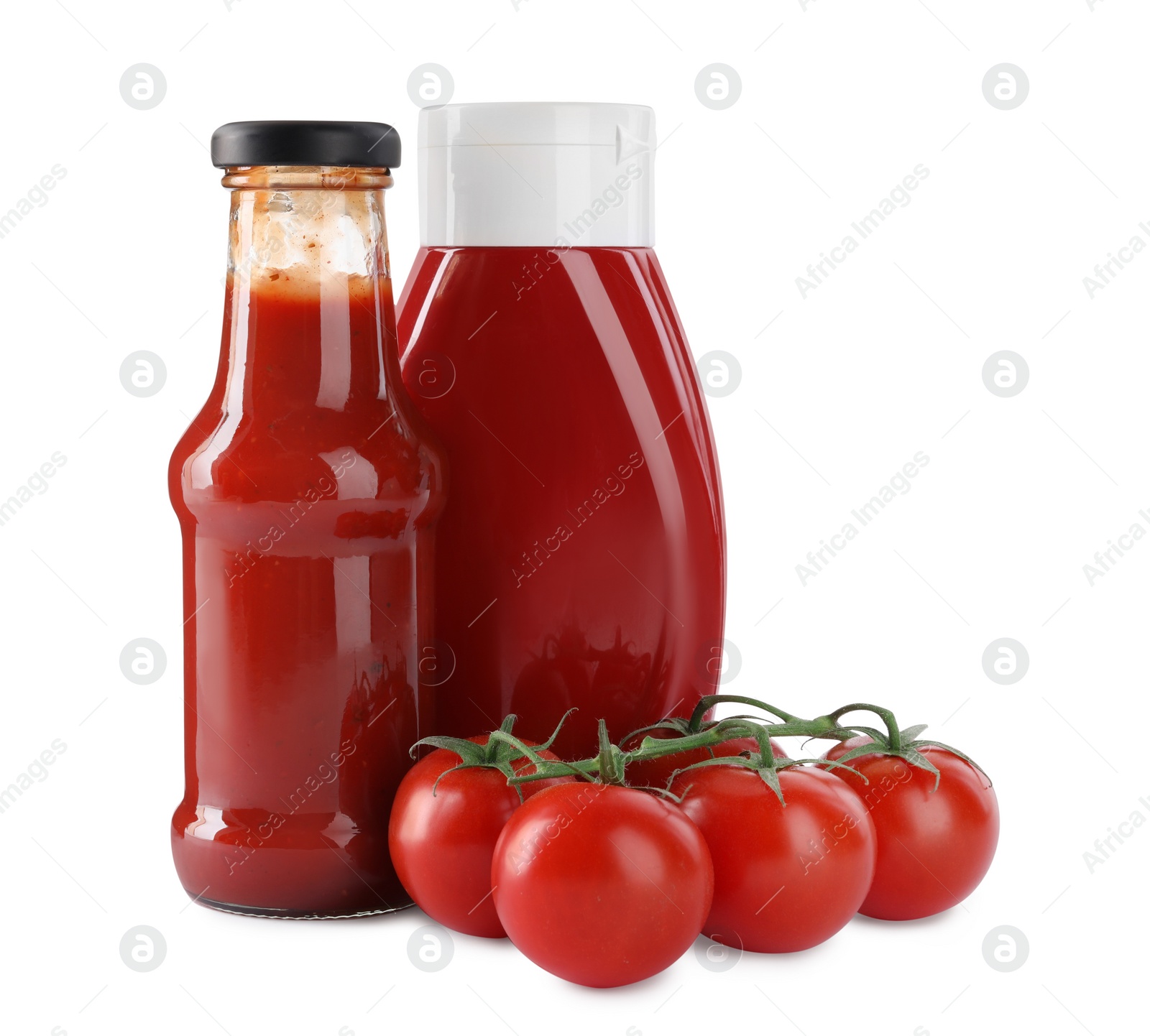 Photo of Different bottles of tasty ketchup and fresh tomatoes isolated on white