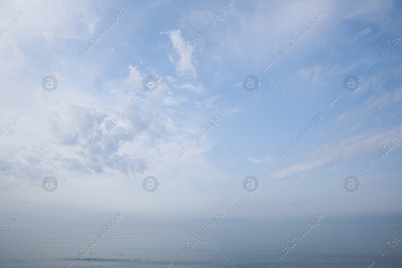 Photo of Picturesque view of beautiful blue sky with white clouds over sea