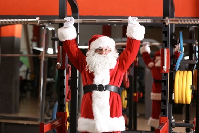 Photo of Authentic Santa Claus training in modern gym