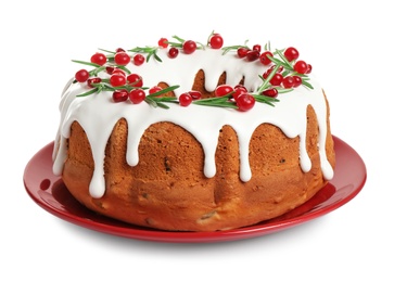 Photo of Traditional Christmas cake decorated with glaze, pomegranate seeds, cranberries and rosemary isolated on white