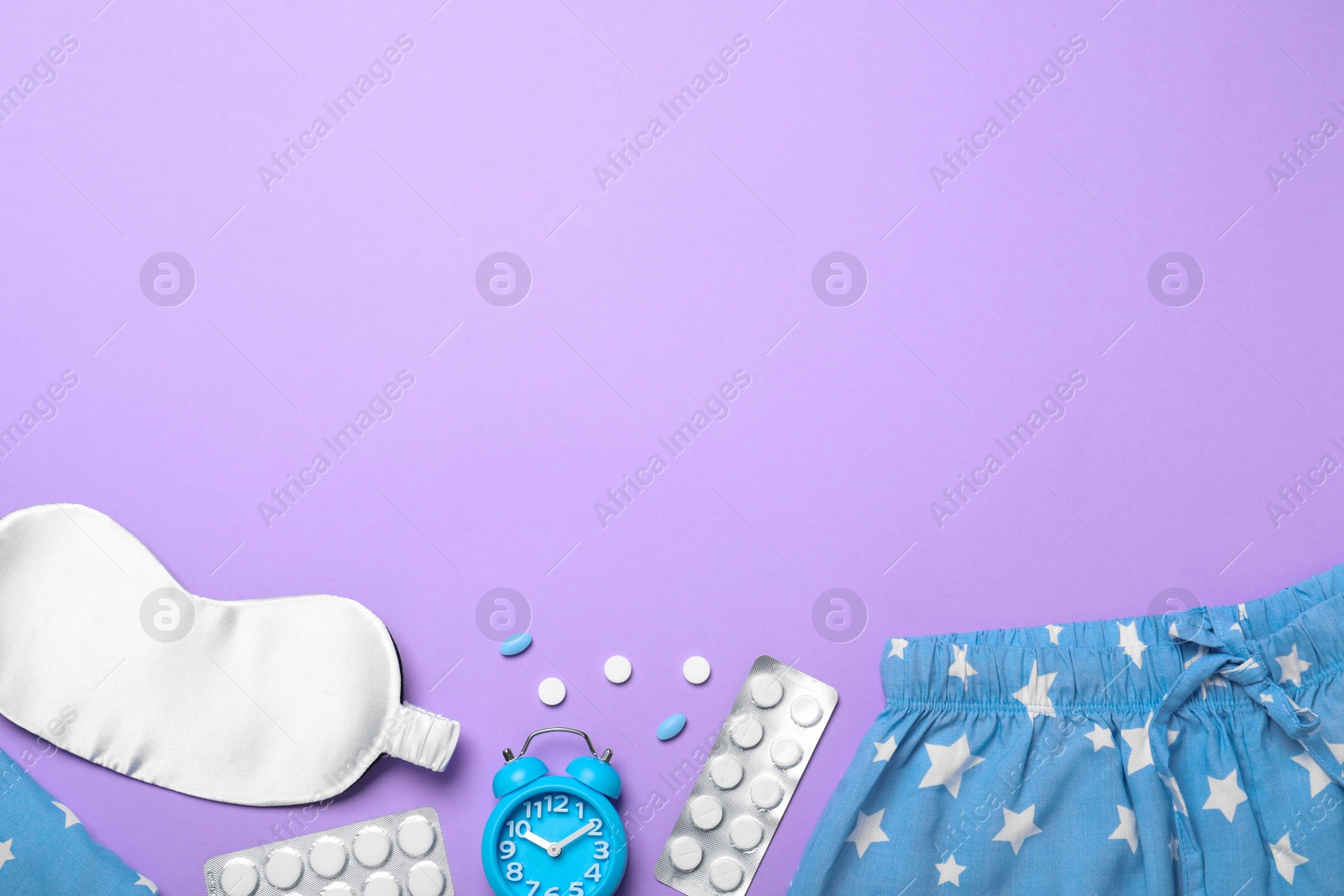 Photo of Flat lay composition with sleeping mask on violet background, space for text. Bedtime accessories