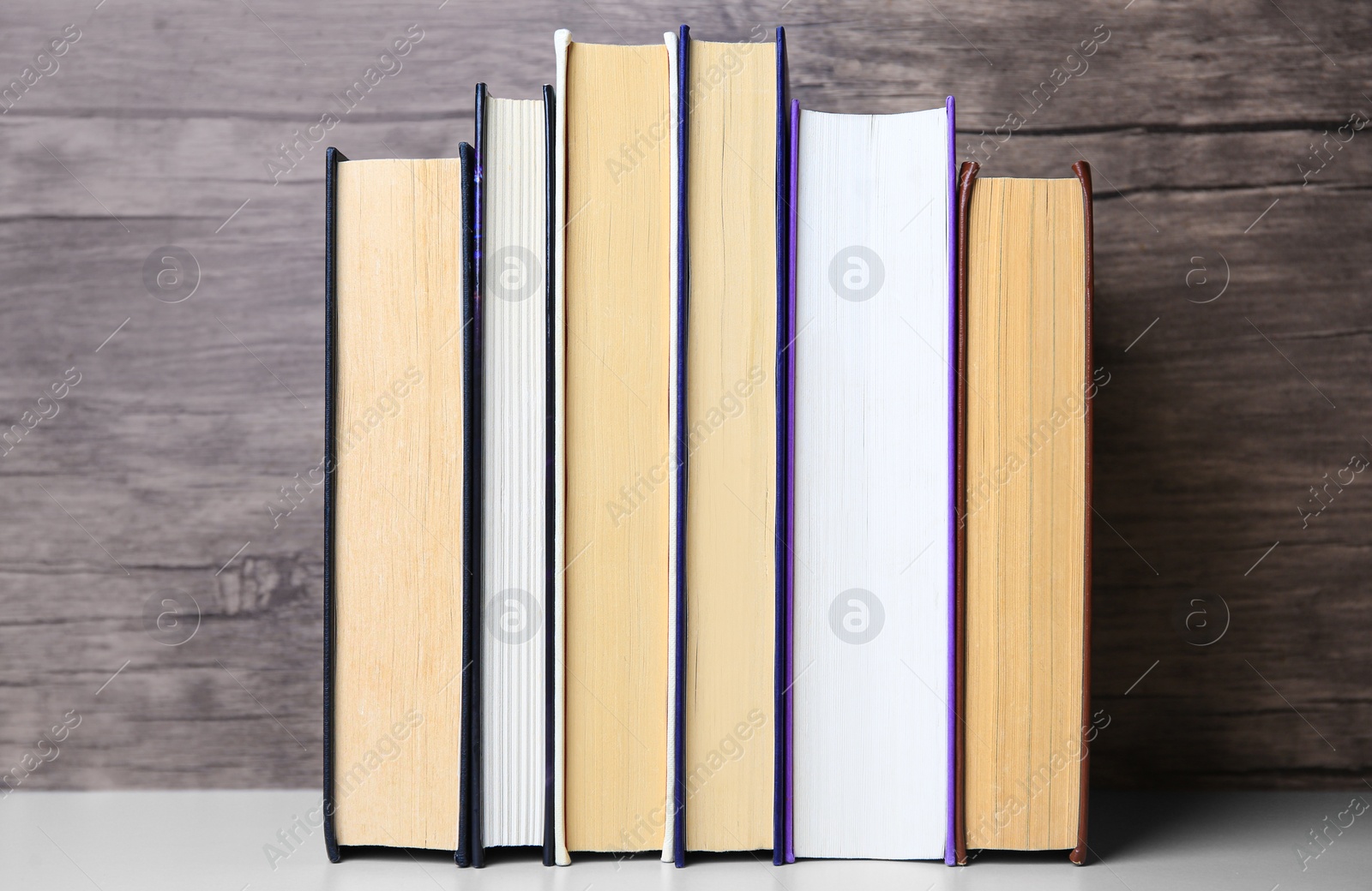 Photo of Collection of different books on white shelf