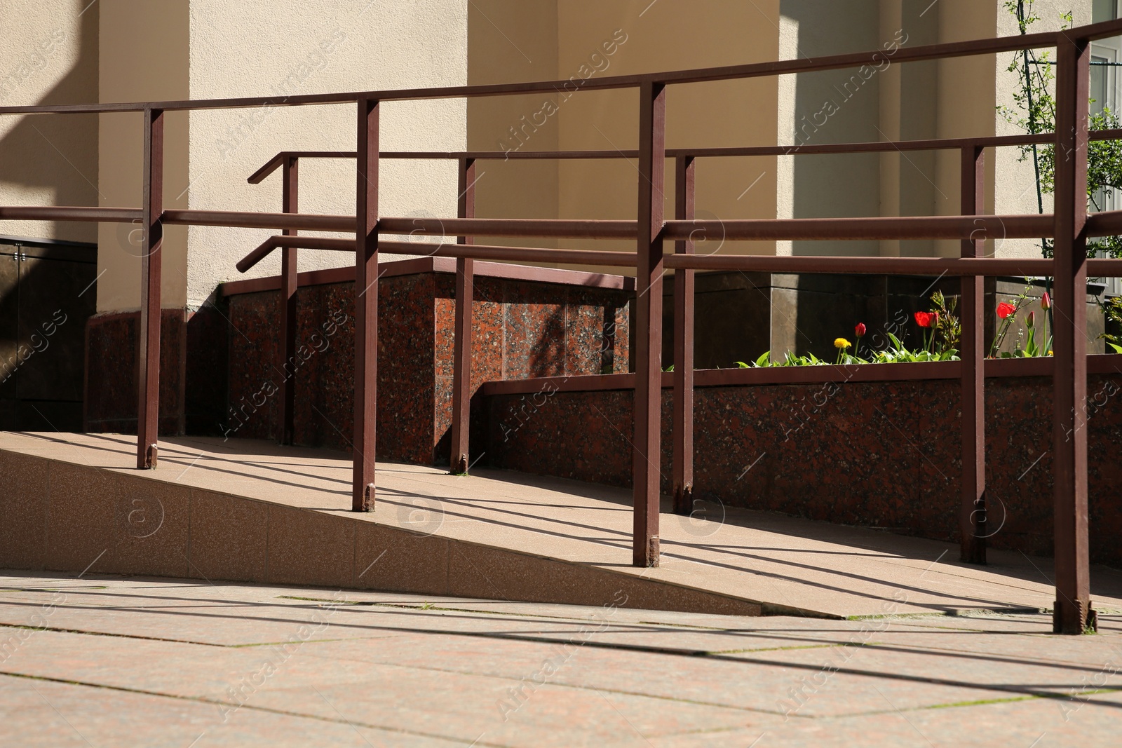 Photo of Ramp with metal handrails near building outdoors