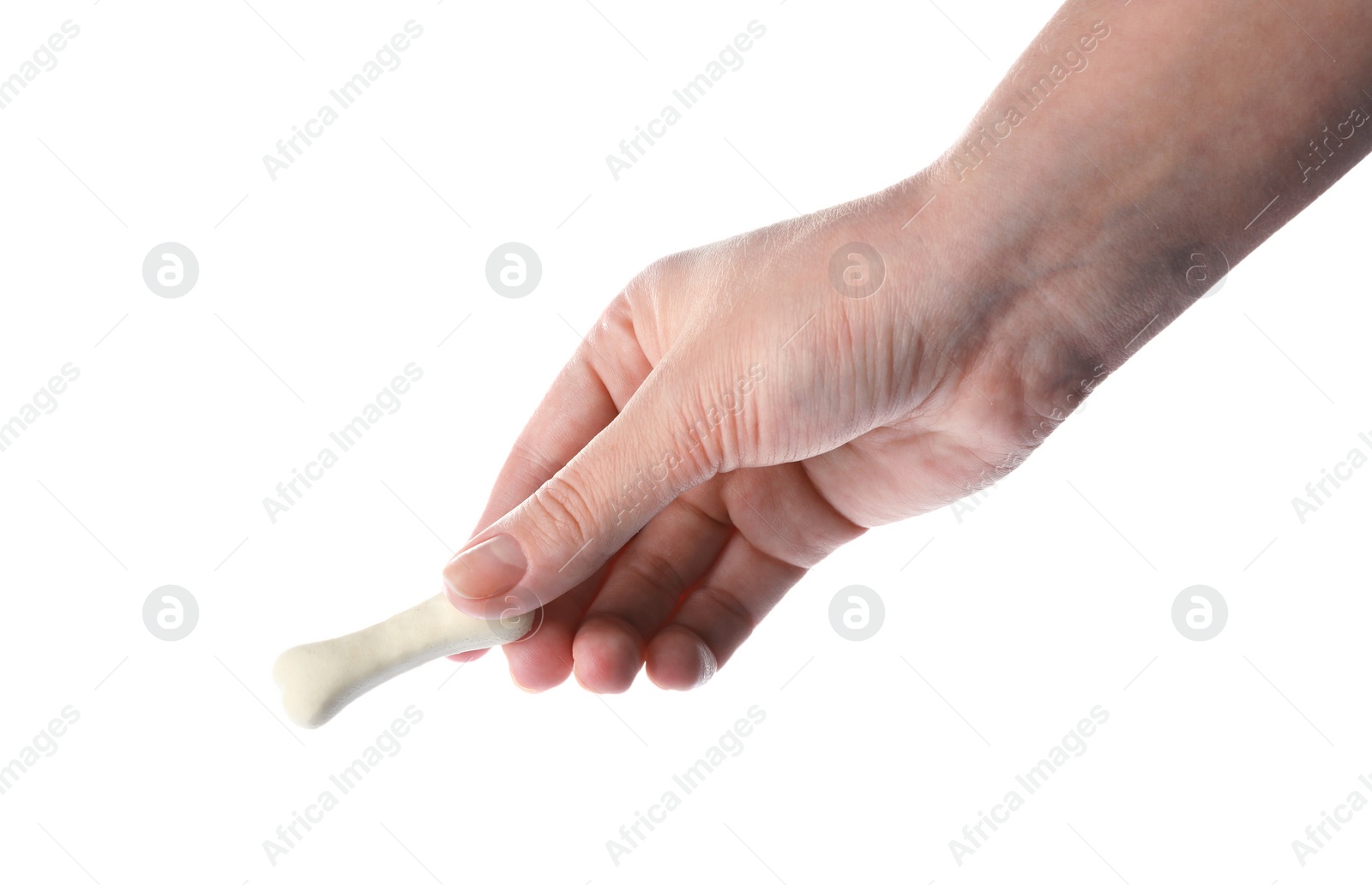 Photo of Woman holding bone shaped dog cookie on white background, closeup