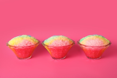 Photo of Rainbow shaving ice in glass dessert bowls on pink background