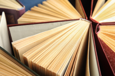 Many different hardcover books as background, closeup