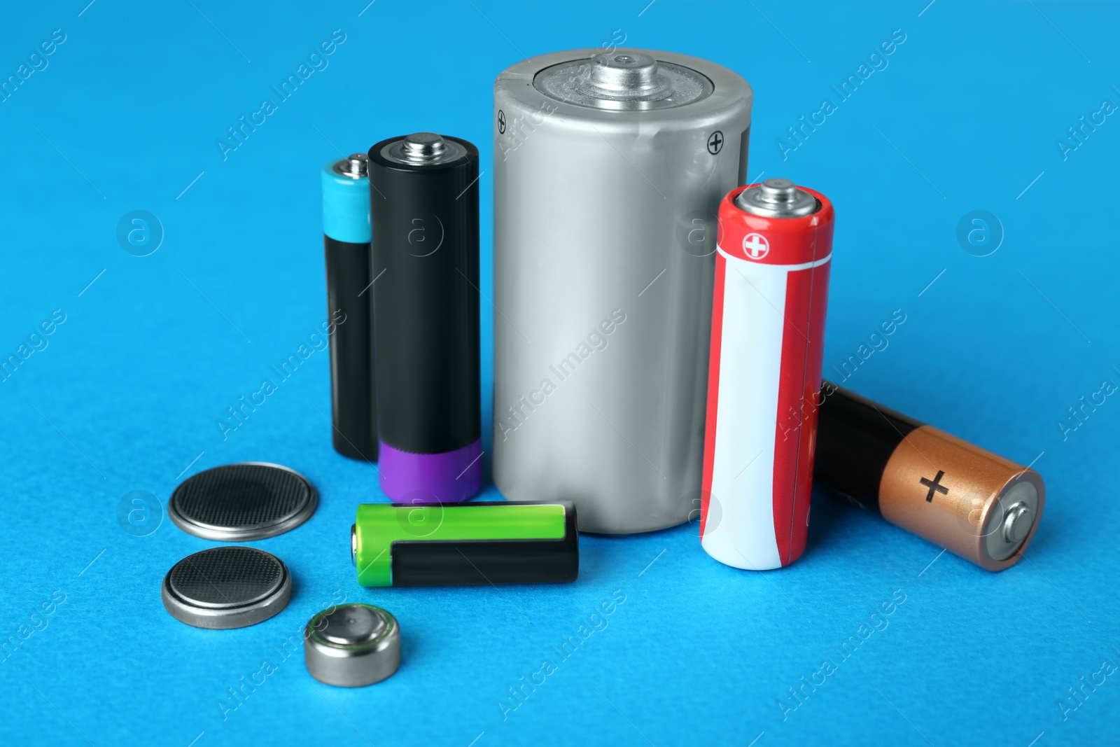 Image of Different types of batteries on light blue background