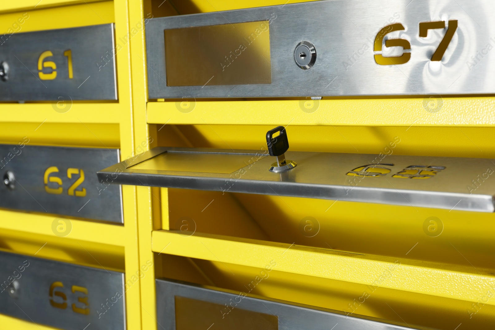 Photo of Open metal mailbox with key and numbers, closeup