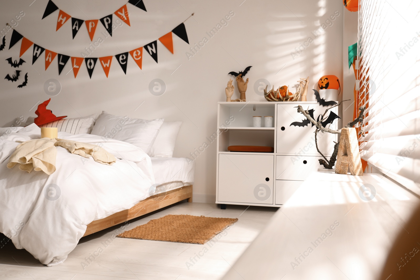 Photo of Stylish bedroom interior with festive Halloween decor