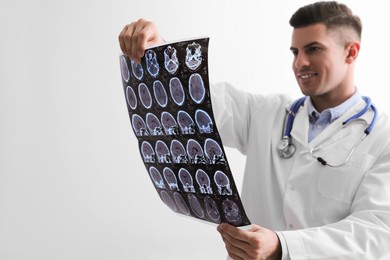Photo of Doctor examining MRI images of patient with multiple sclerosis in clinic, space for text