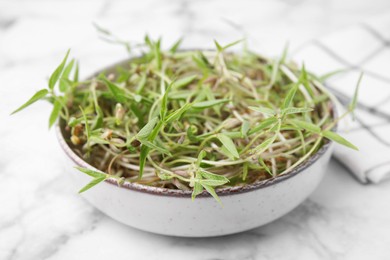 Mung bean sprouts in bowl on white marble table, closeup