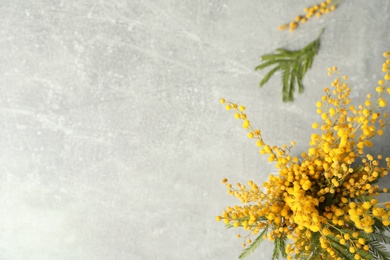 Photo of Bouquet of beautiful mimosa flowers on grey table