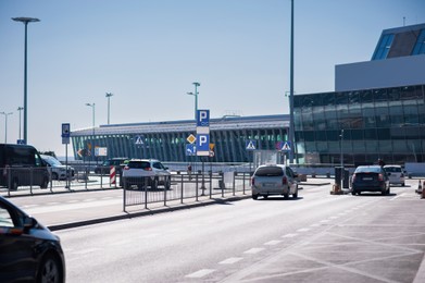 Photo of Different modern cars parked near airport on sunny day