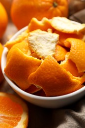 Photo of Orange peels preparing for drying and fresh fruits on table, closeup