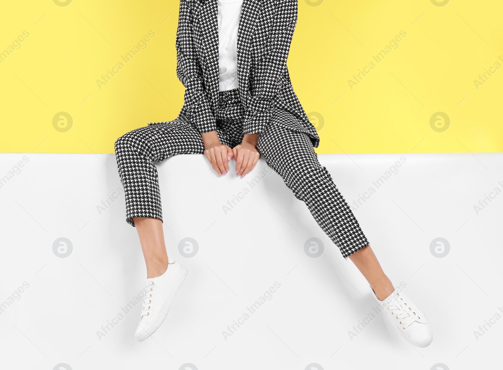 Photo of Woman wearing stylish shoes on color background, closeup