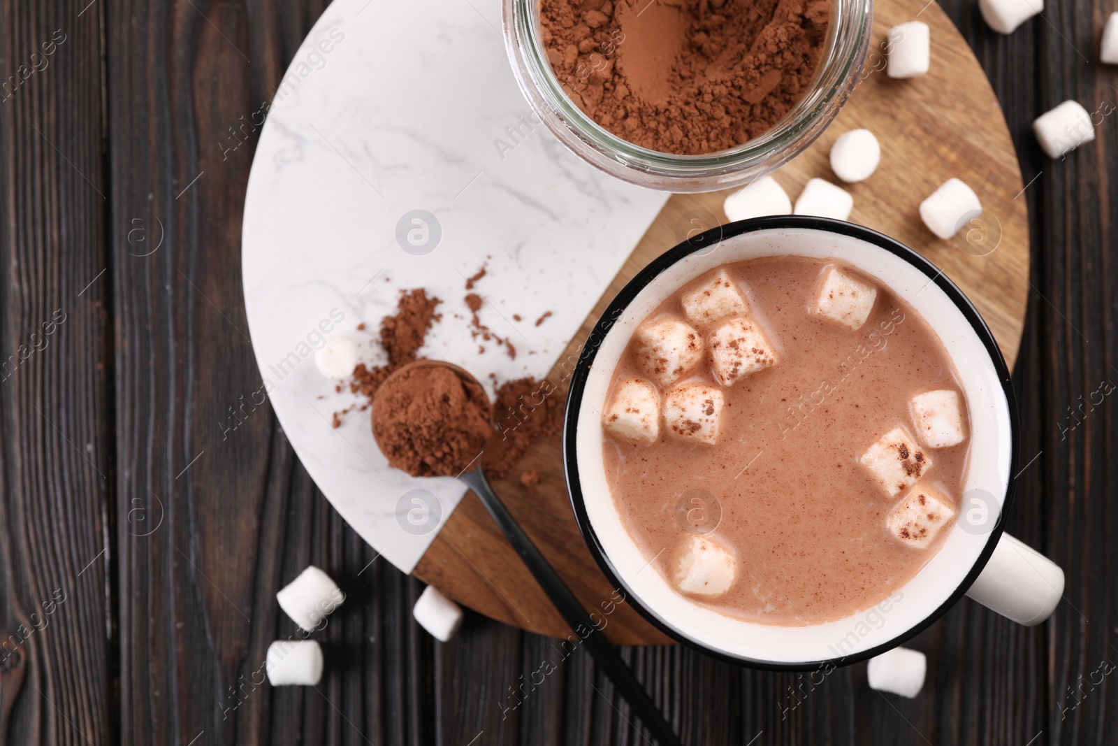 Photo of Cup of aromatic hot chocolate with marshmallows and cocoa powder served on table, top view