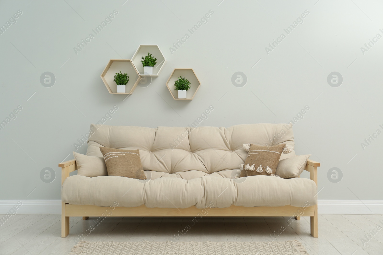 Photo of Stylish beige sofa in living room interior