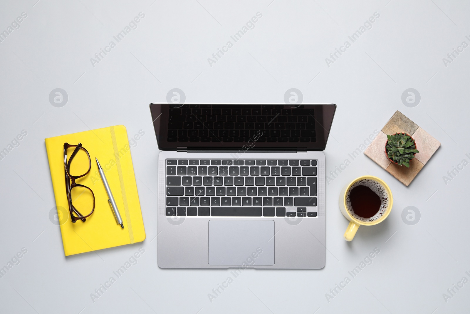 Photo of Flat lay composition with laptop on light background