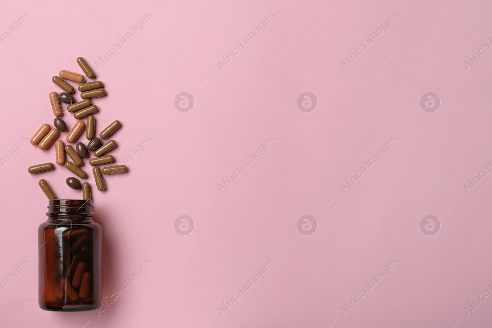 Photo of Bottle with vitamin capsules on color background, flat lay. Space for text