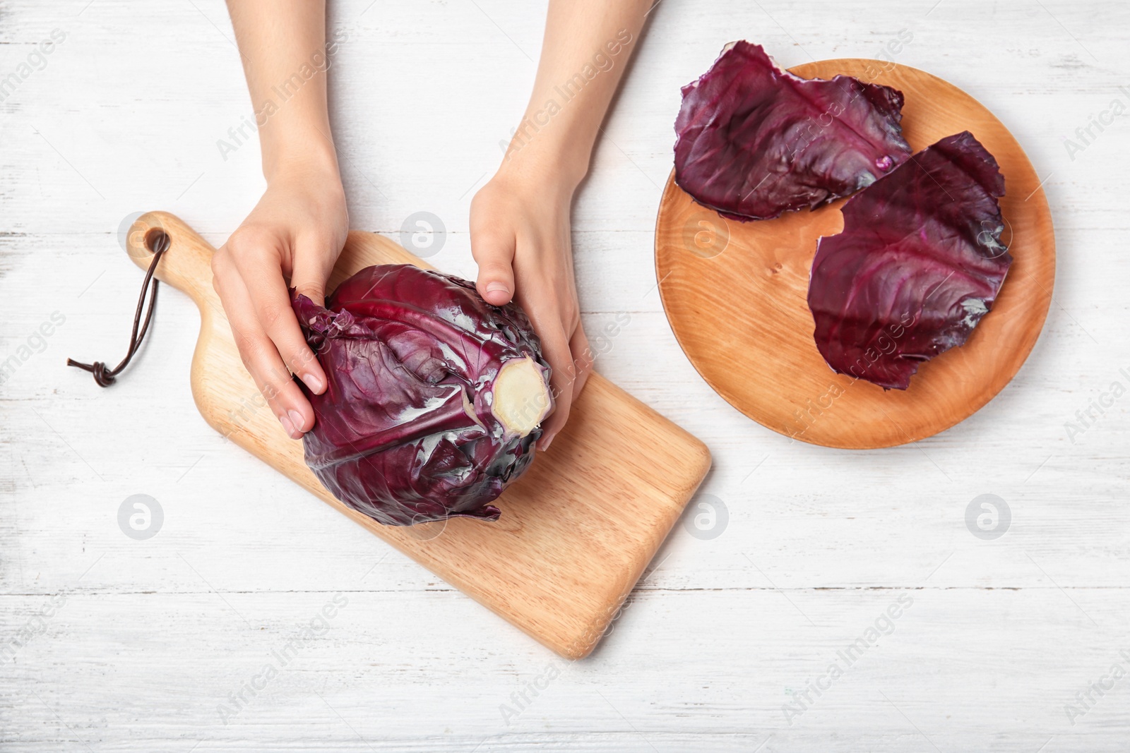 Photo of Woman preparing red cabbage at table, top view