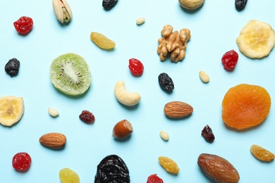 Photo of Flat lay composition of different dried fruits and nuts on color background