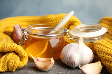 Photo of Composition with garlic and other cold remedies on grey table