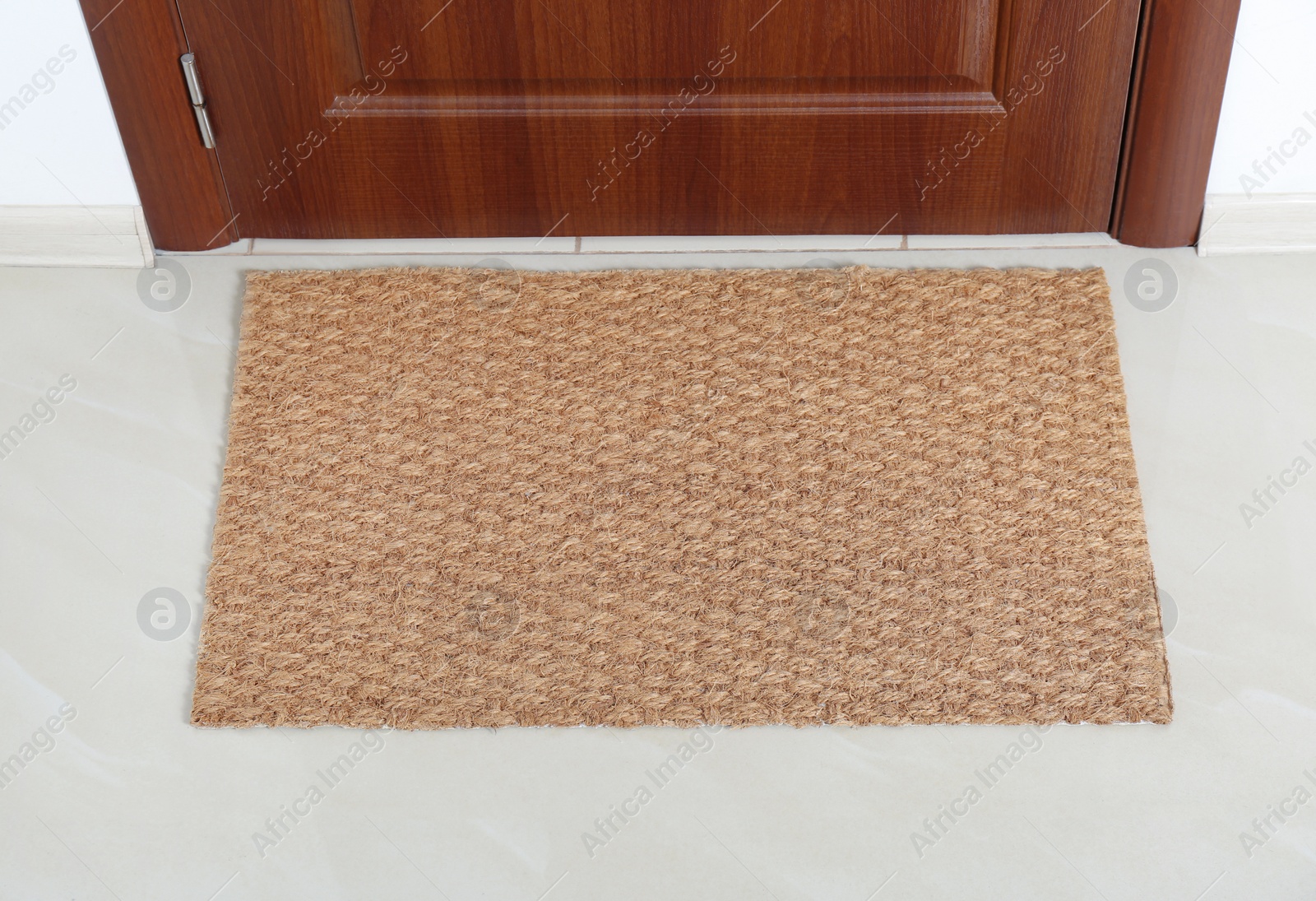 Photo of New clean mat near entrance door. Household item