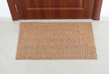 New clean mat near entrance door. Household item