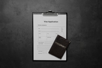 Photo of Visa application form for immigration and passport on grey table, top view