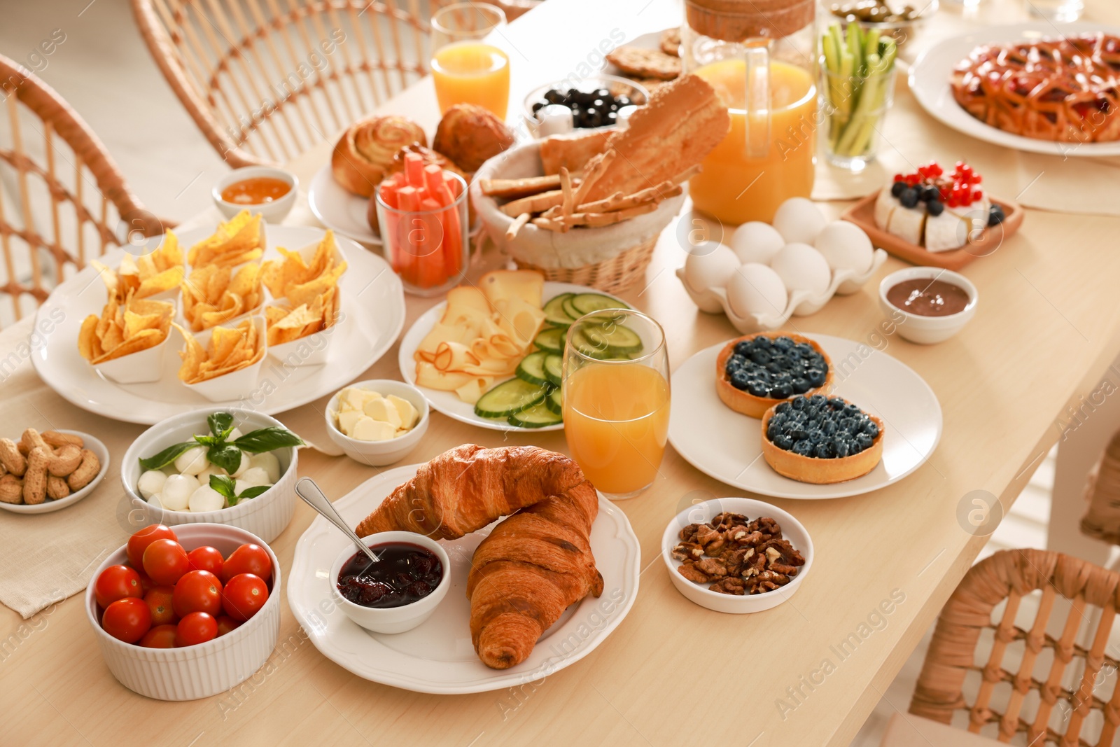 Photo of Dishes with different food on table indoors. Luxury brunch