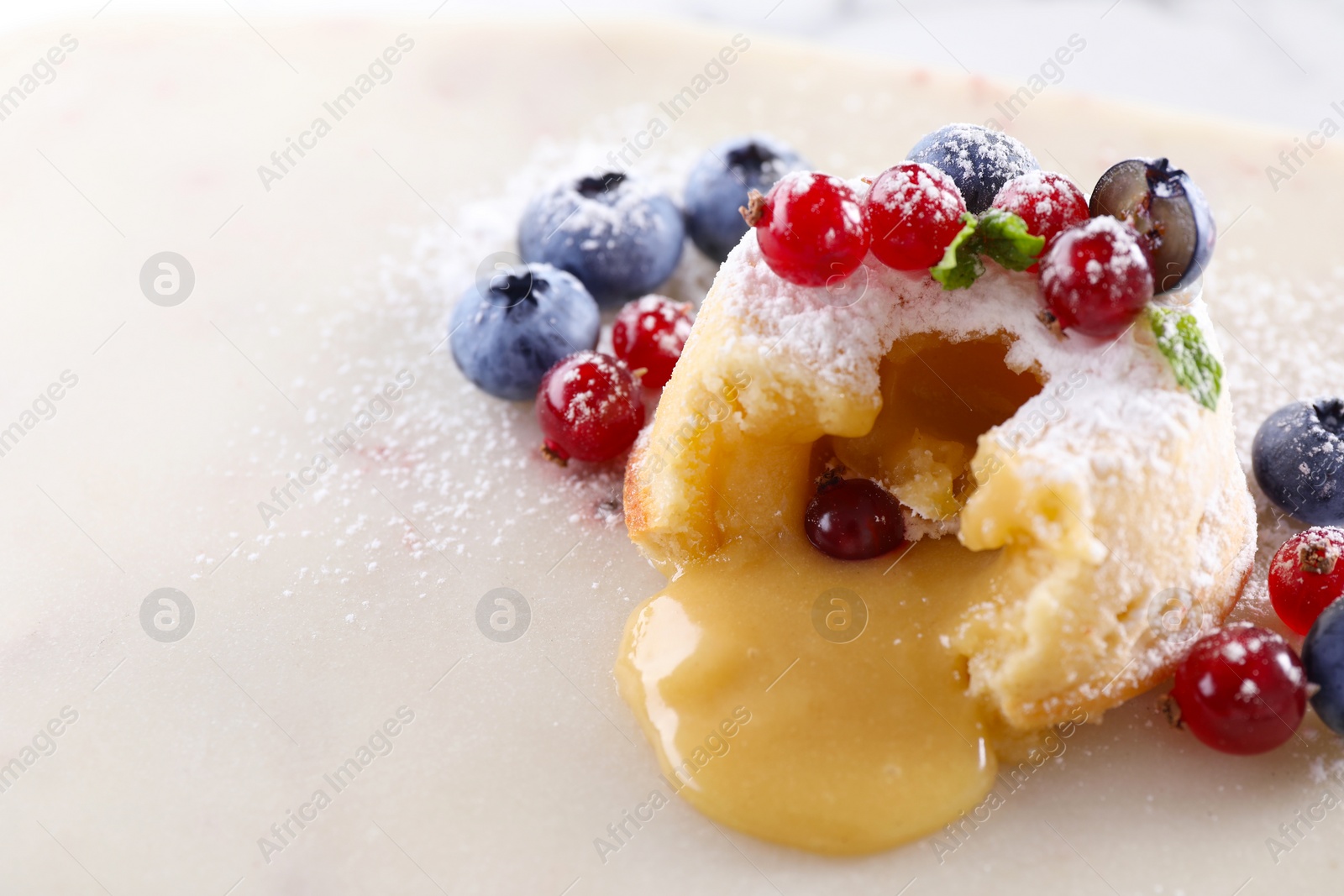 Photo of Tasty vanilla fondant with white chocolate and berries on white table, closeup. Space for text