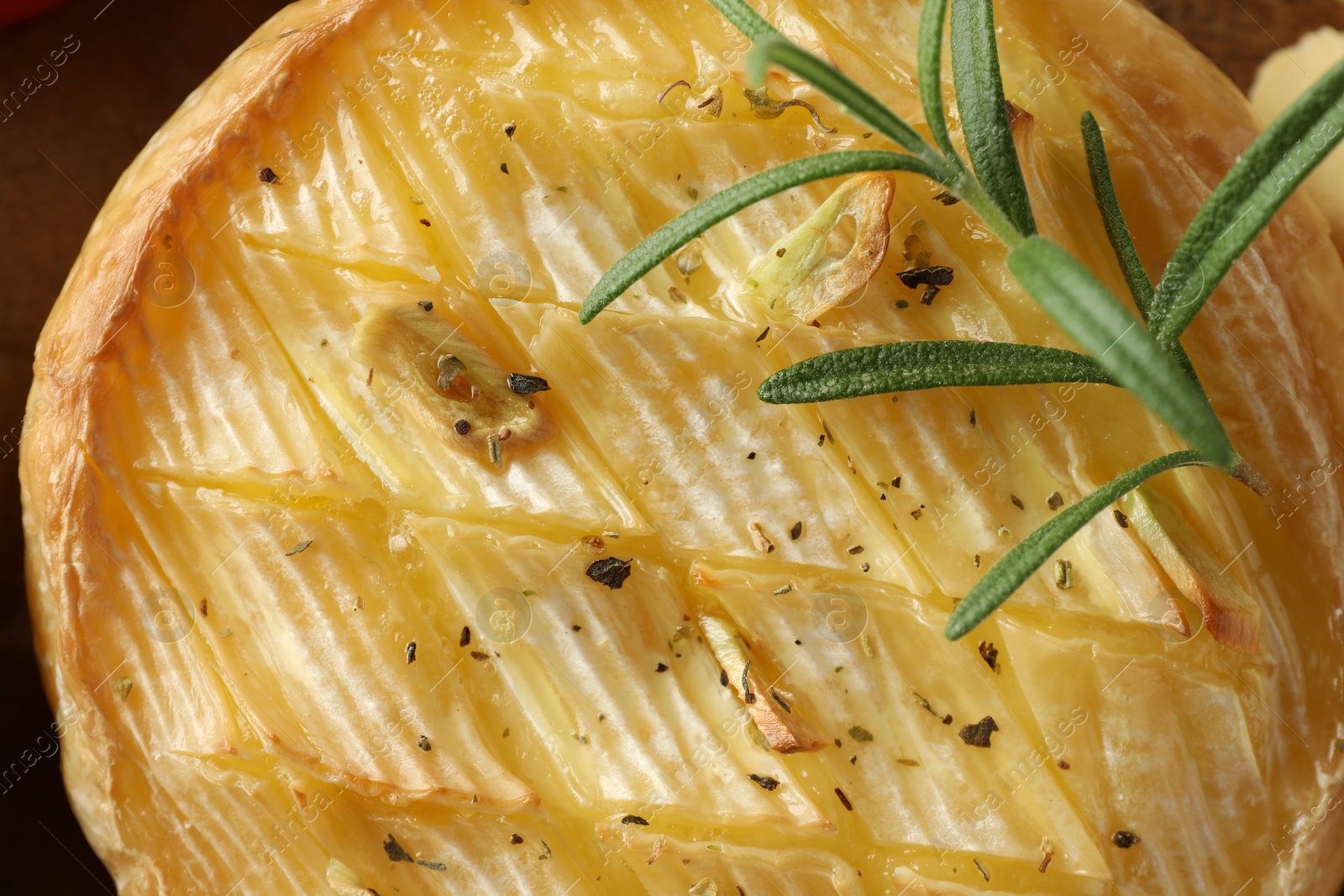 Photo of Tasty baked brie cheese with rosemary, top view