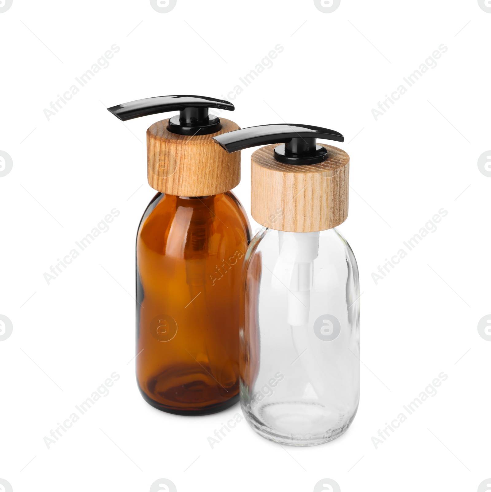 Photo of Two empty glass bottles with dispenser caps on white background