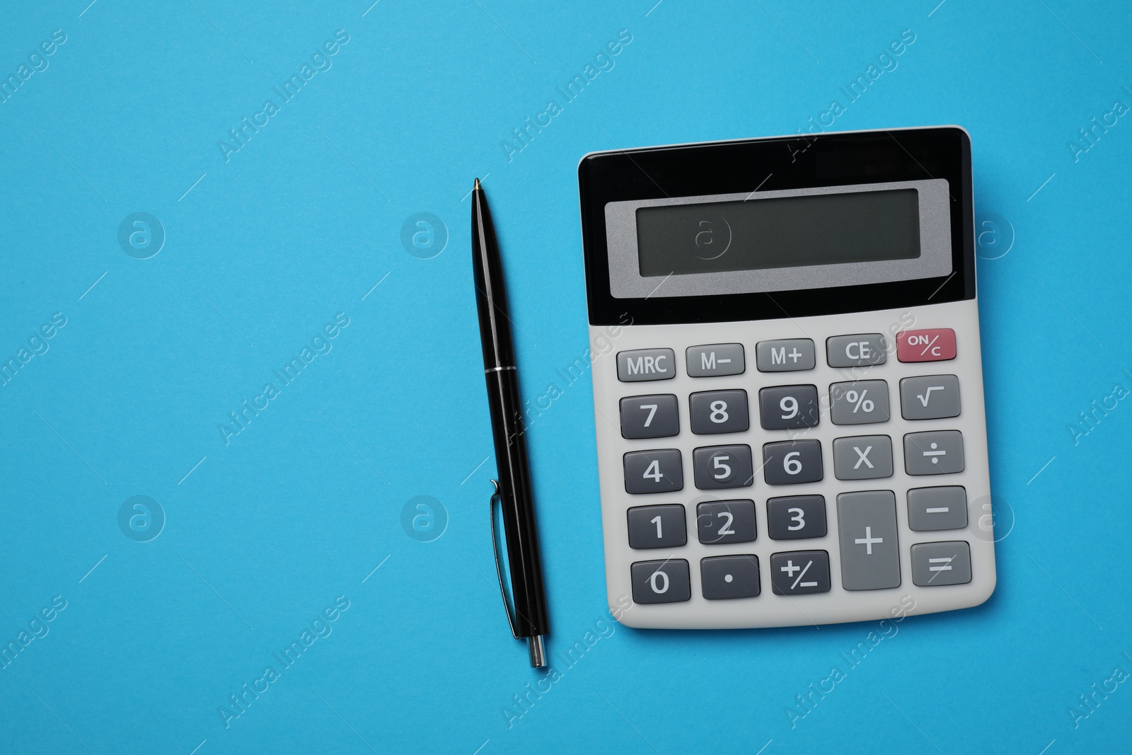 Photo of Calculator and pen on light blue background, flat lay with space for text