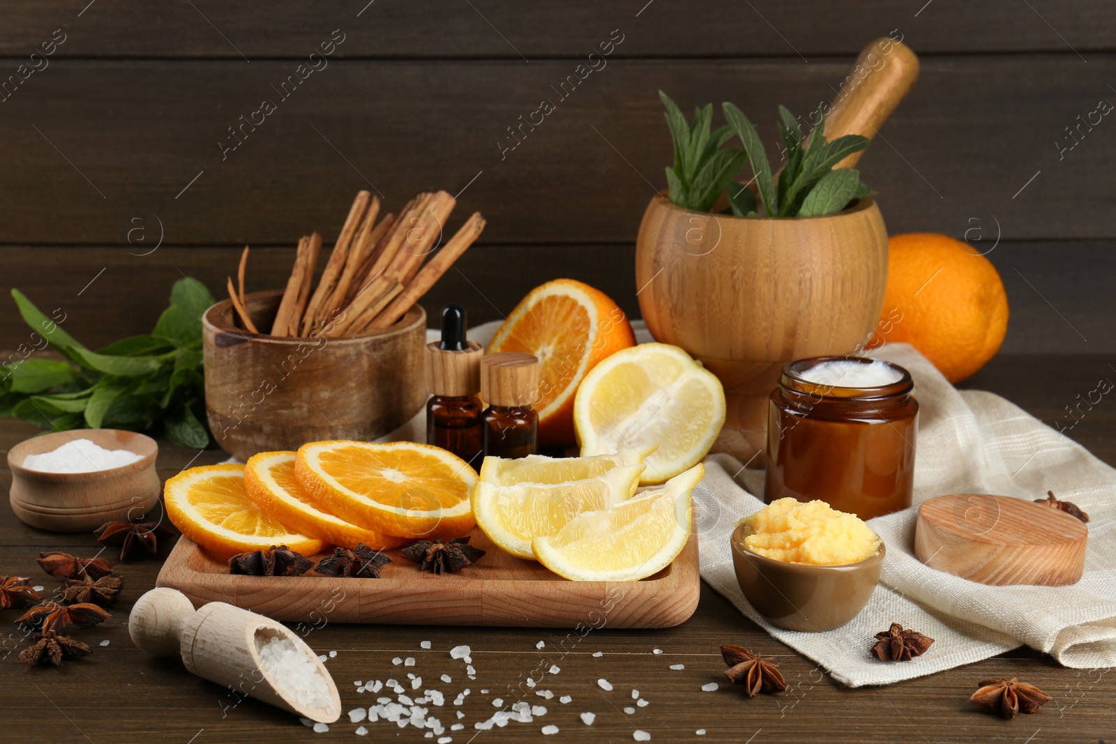 Photo of Homemade cosmetic products and fresh ingredients on wooden table