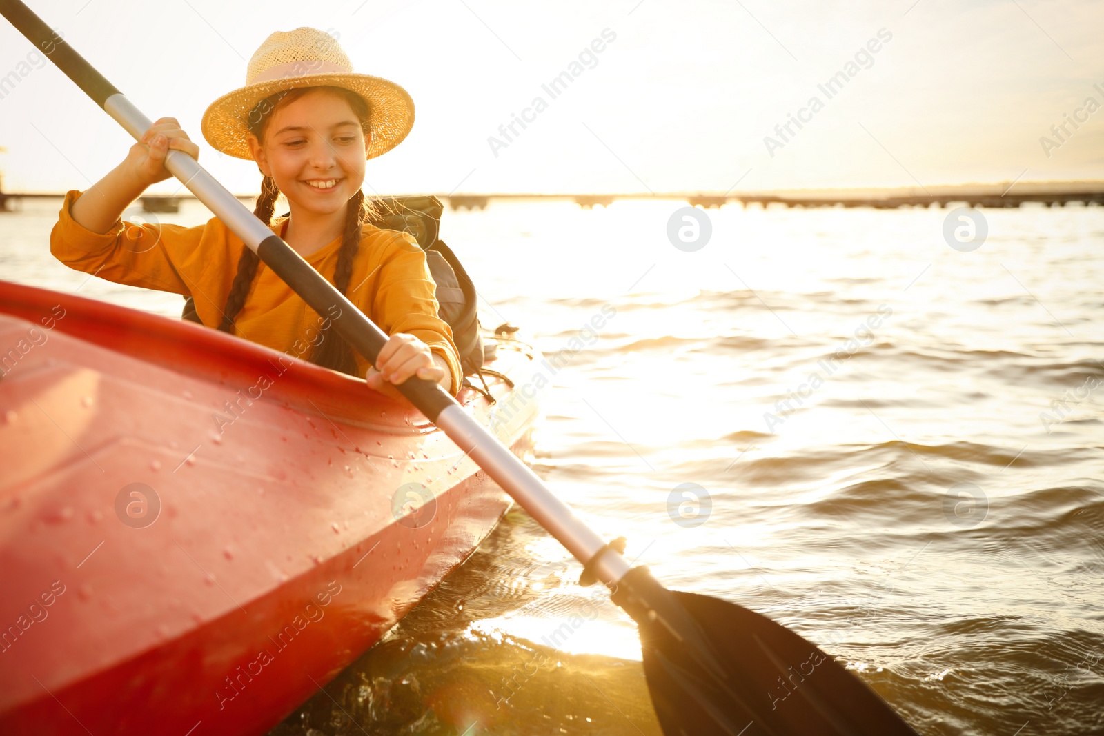 Photo of Happy girl kayaking on river. Summer camp activity