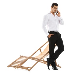 Photo of Young businessman with phone near sun lounger against white background. Beach accessory