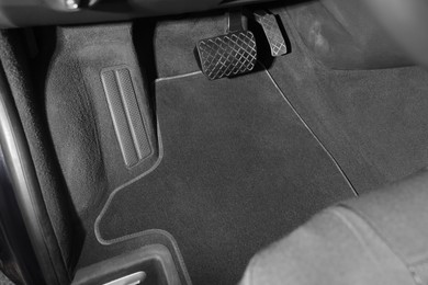 Photo of Grey soft floor carpet in car, closeup