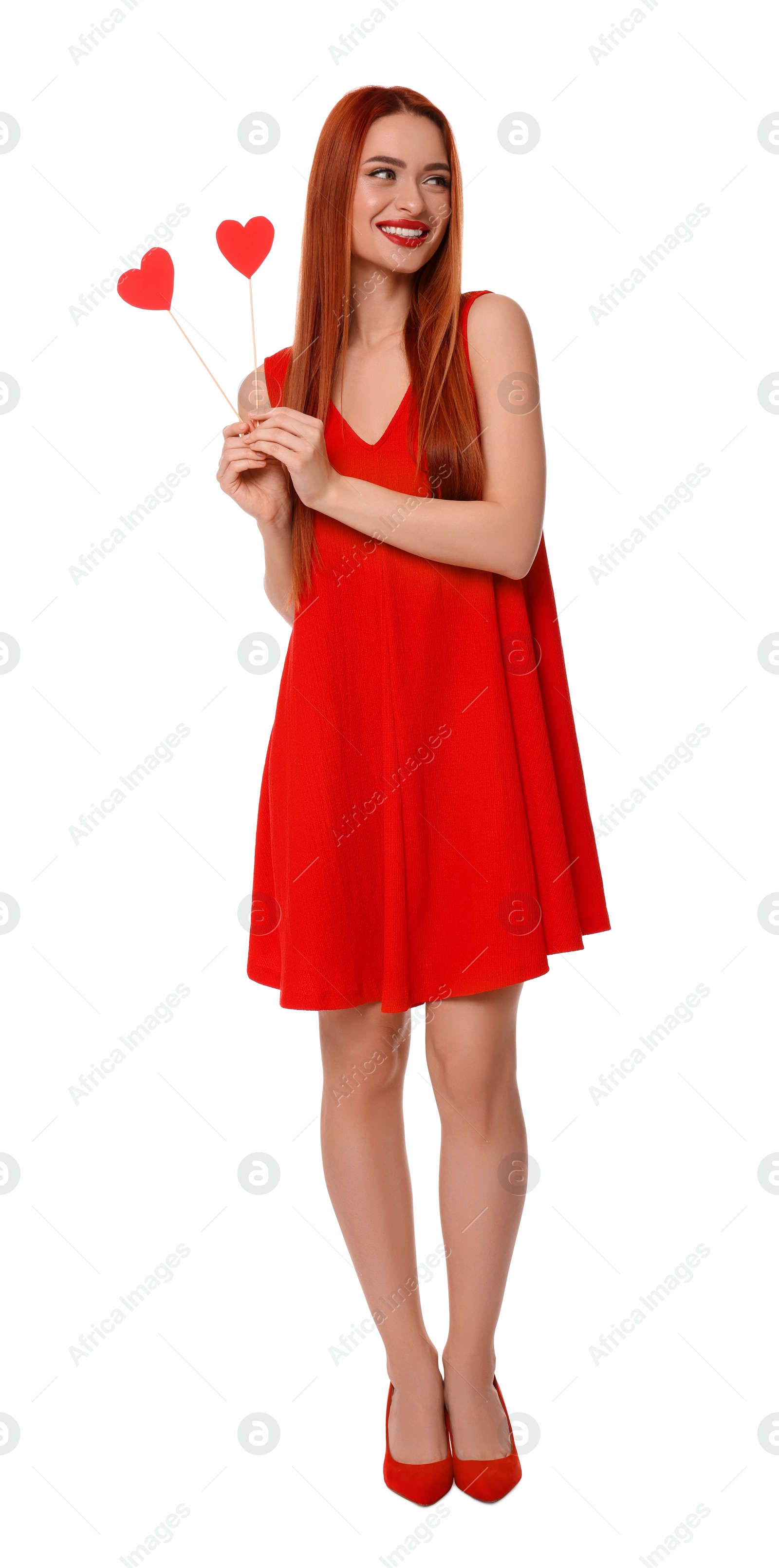 Photo of Young woman in red dress with paper hearts on white background