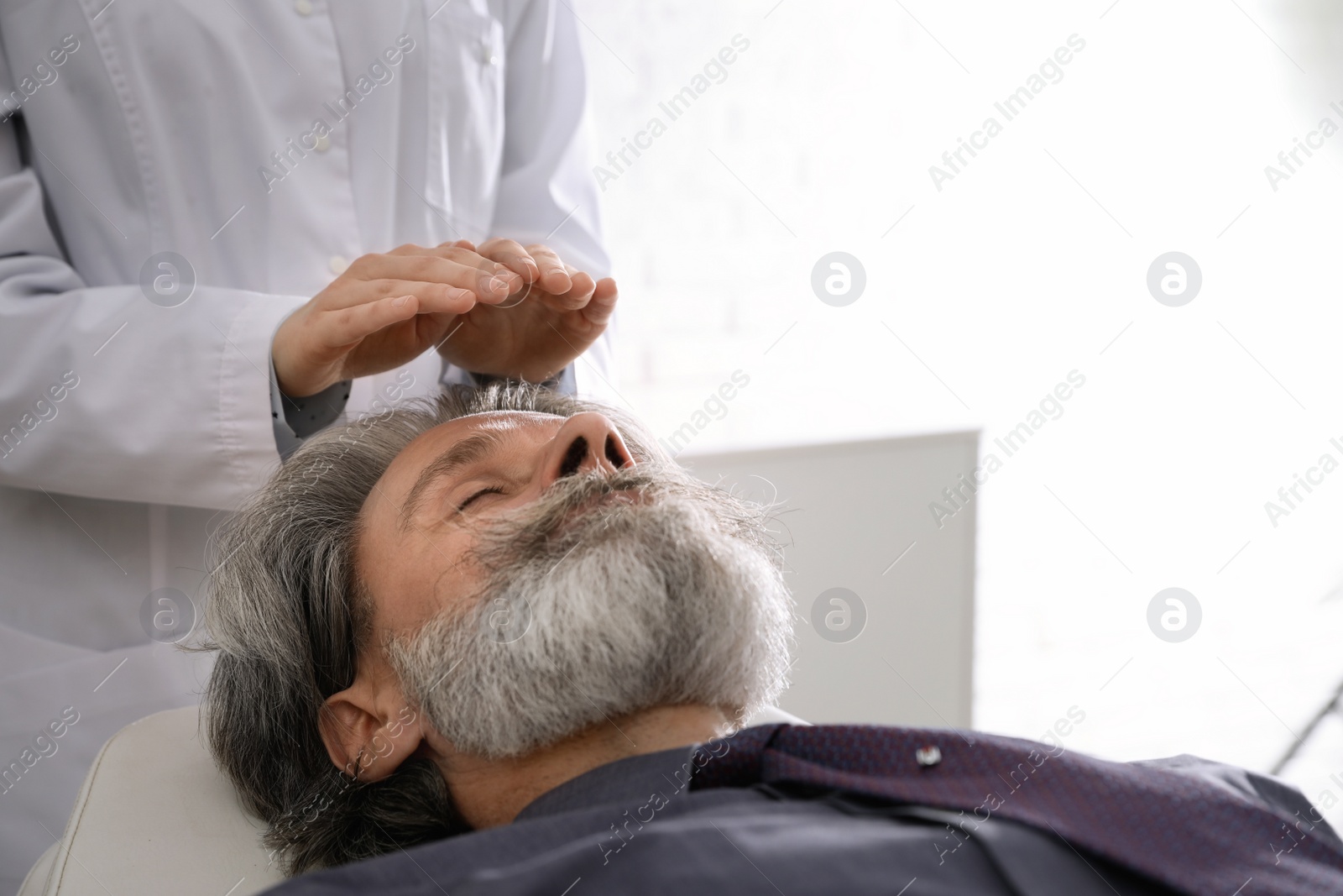 Photo of Psychotherapist and patient in office. Hypnotherapy session