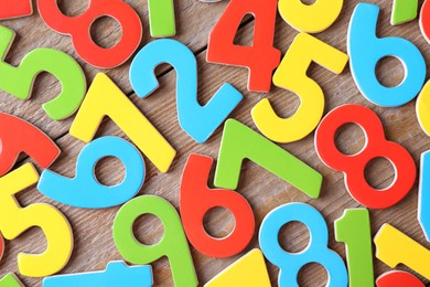 Colorful numbers on wooden table, flat lay