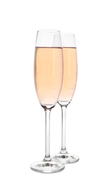 Glasses of sparkling rose champagne isolated on white