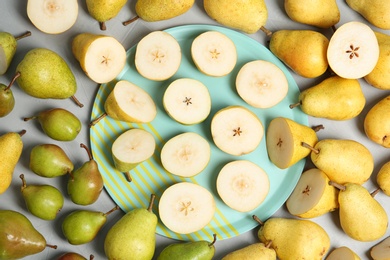 Flat lay composition with fresh ripe pears and tray on gray background