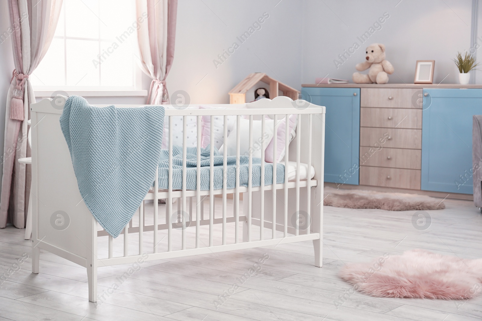 Photo of Baby room interior with comfortable crib