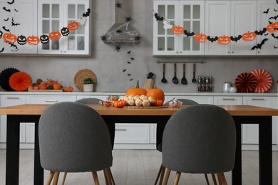Photo of Stylish kitchen interior with festive decor. Halloween celebration