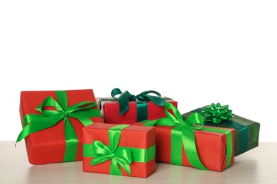 Red and green gift boxes on wooden table against white background