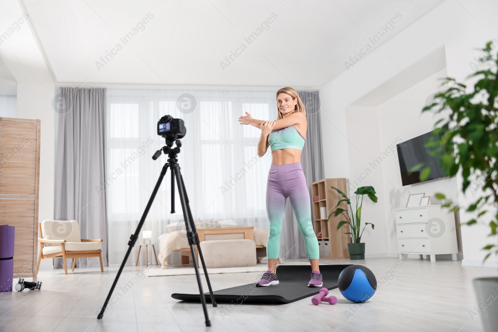 Photo of Fitness trainer recording online classes at home